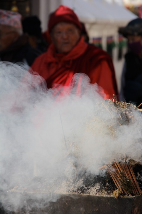 Burning incense surrounds the stupa